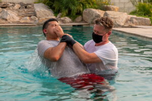 Jehovah’s Witnesses being baptized according to safety guidelines
