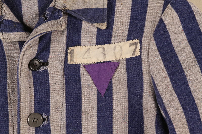 Concentration camp uniform jacket with a purple triangle worn by a Jehovah’s Witness inmate